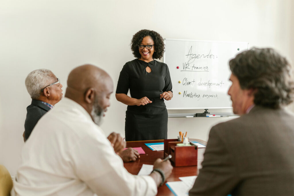 Woman Talking in Front of Colleagues